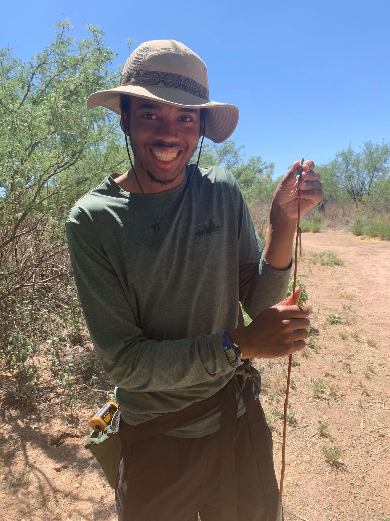 AWRR Research Fellow Marcus Williams holds an Ornate Tree Lizard.